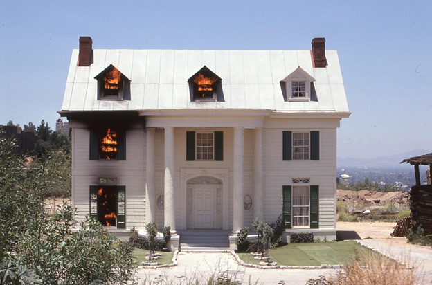 flames in windows of home