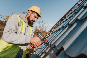 roofer installing metal roof