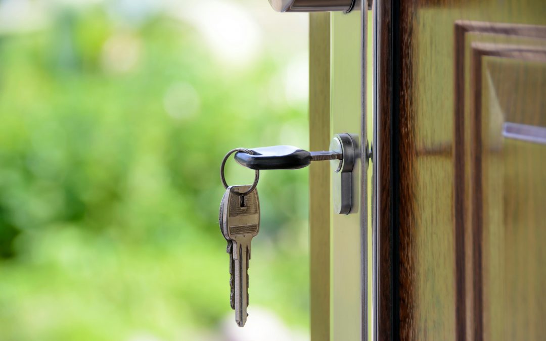 keys hanging from the door of a new home