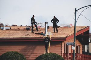 two men replacing room on home