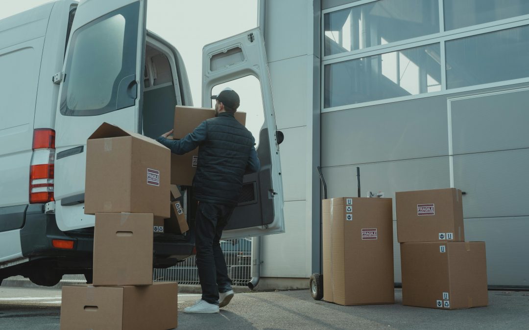 a man packing his fragile belongings into a moving van