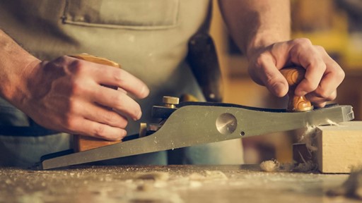 man using wood planer