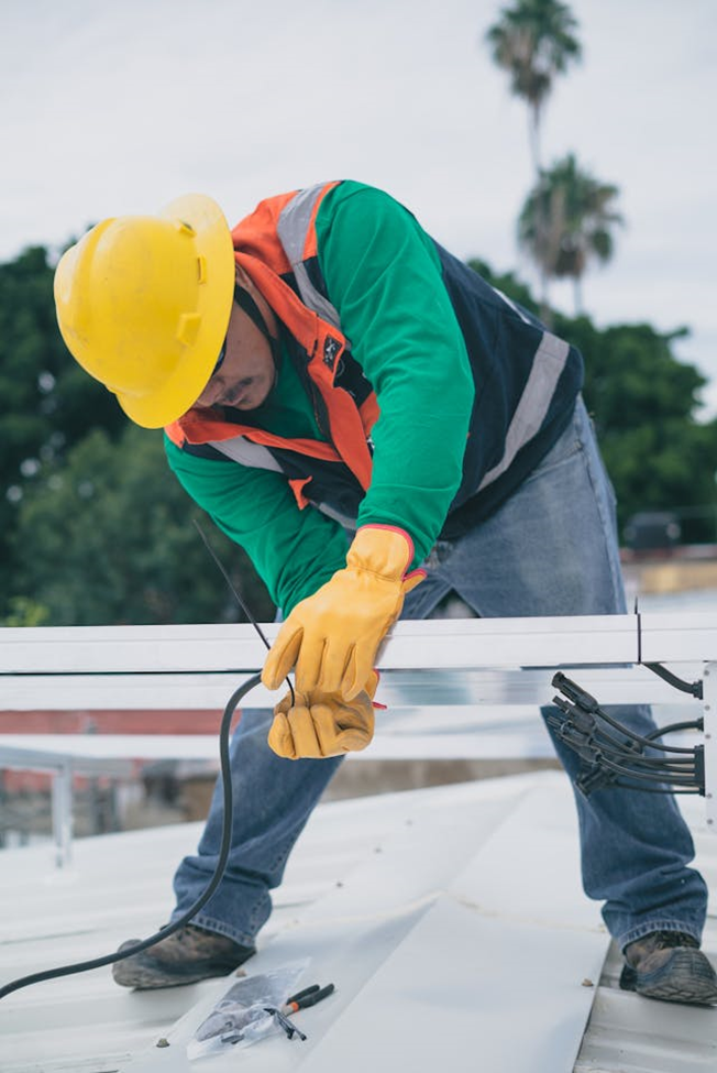 man moving beam on roof