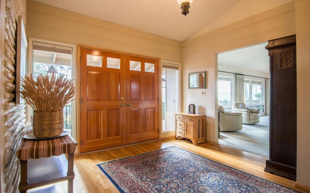 beautiful home foyer with a large running rug in the doorway