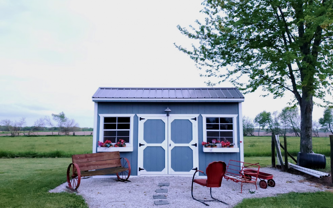 small prefab shed with gravel walkway