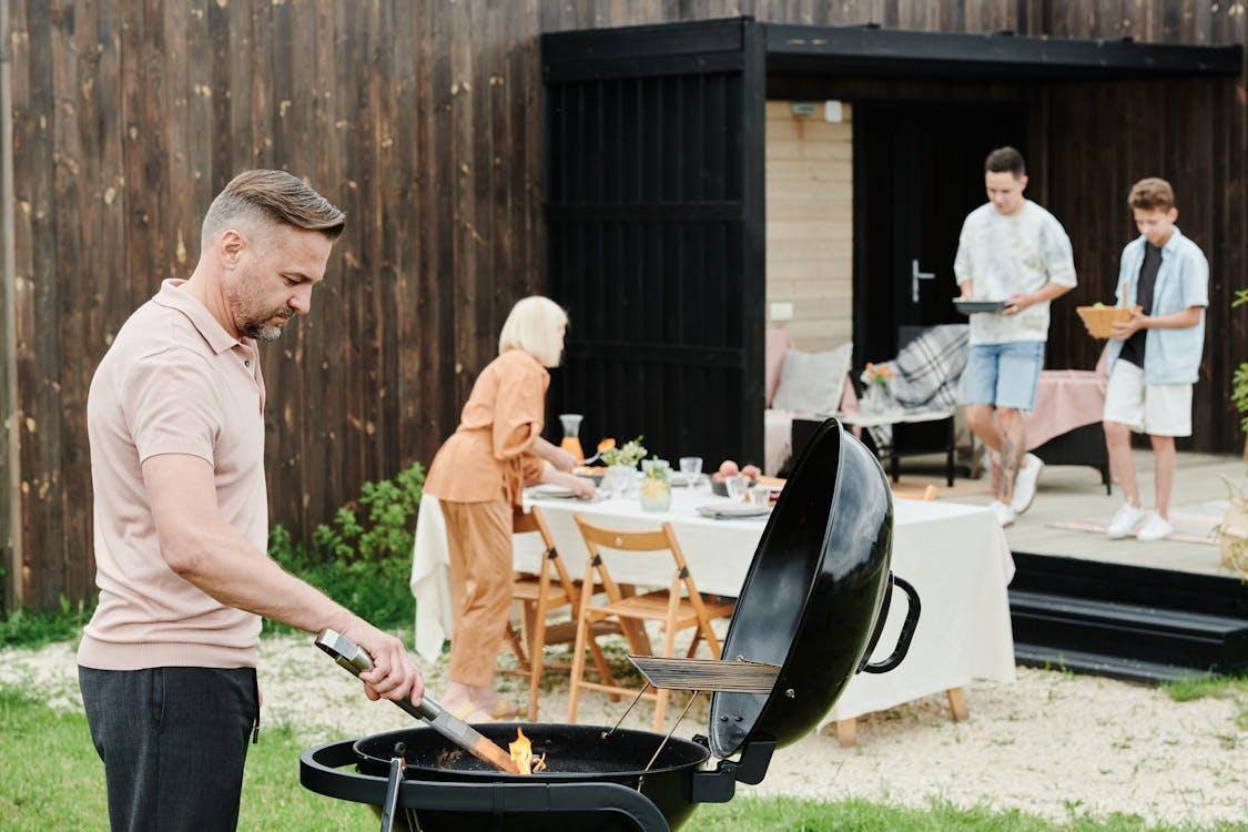 family cooking and prepping meals in the backyard