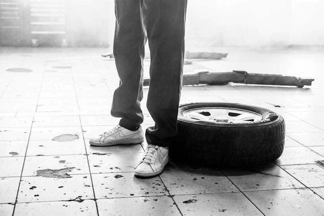 Man standing next to tire