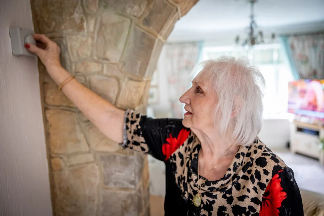 Woman updating thermostat