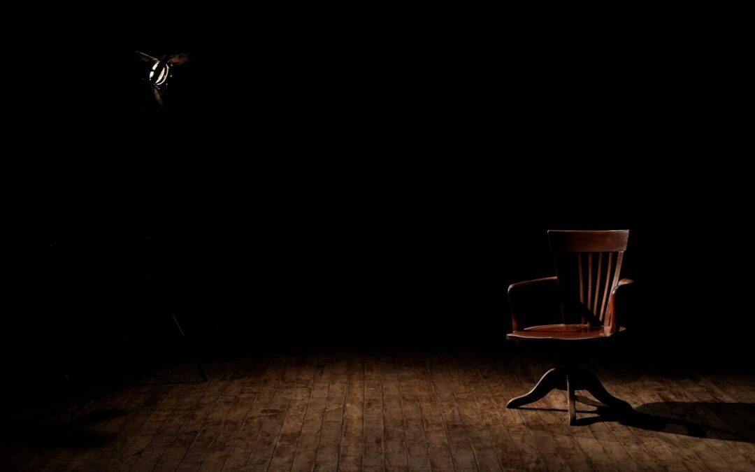 wooden chair in dark room