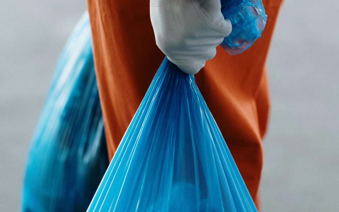 trash collector with gloves carrying trash