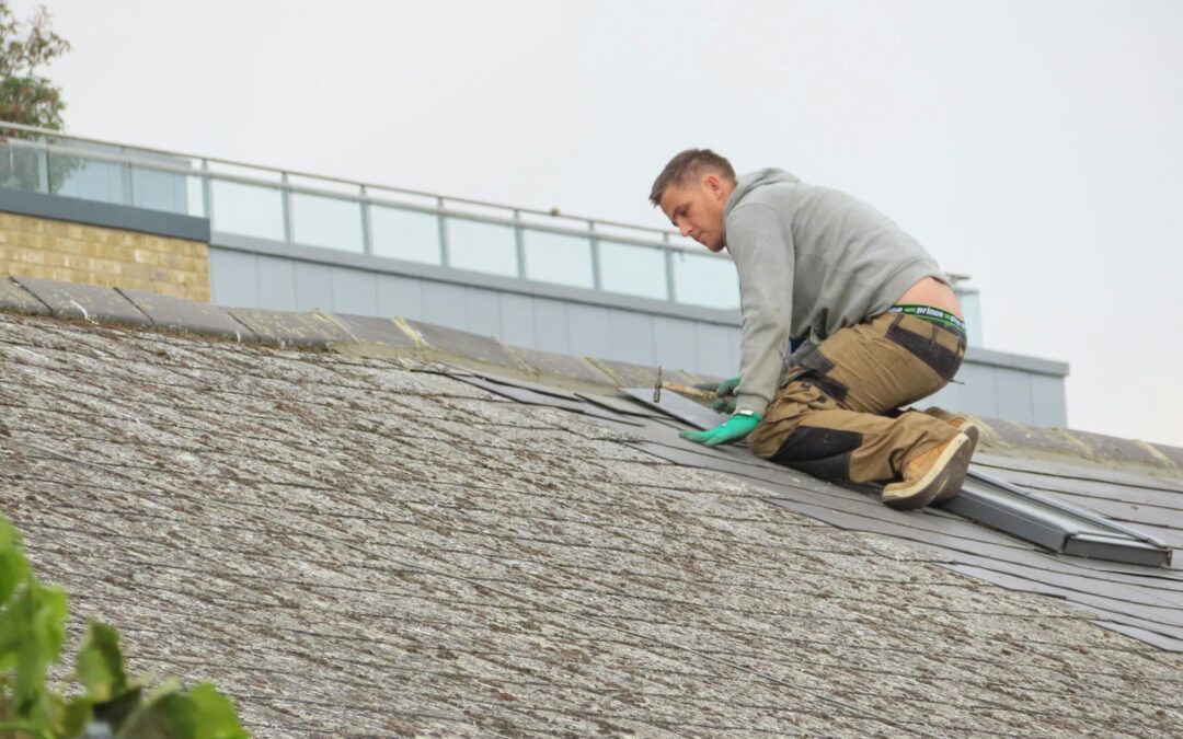 man on roof doing work