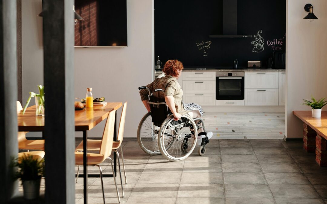 Photo of Woman on Wheelchair Going to the Kitchen