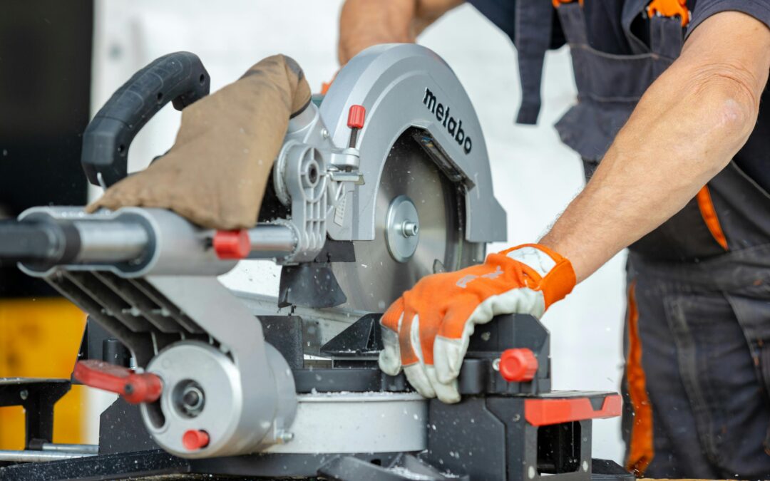 man using a circular saw with gloves