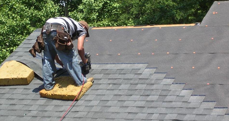 man on roof doing repairs