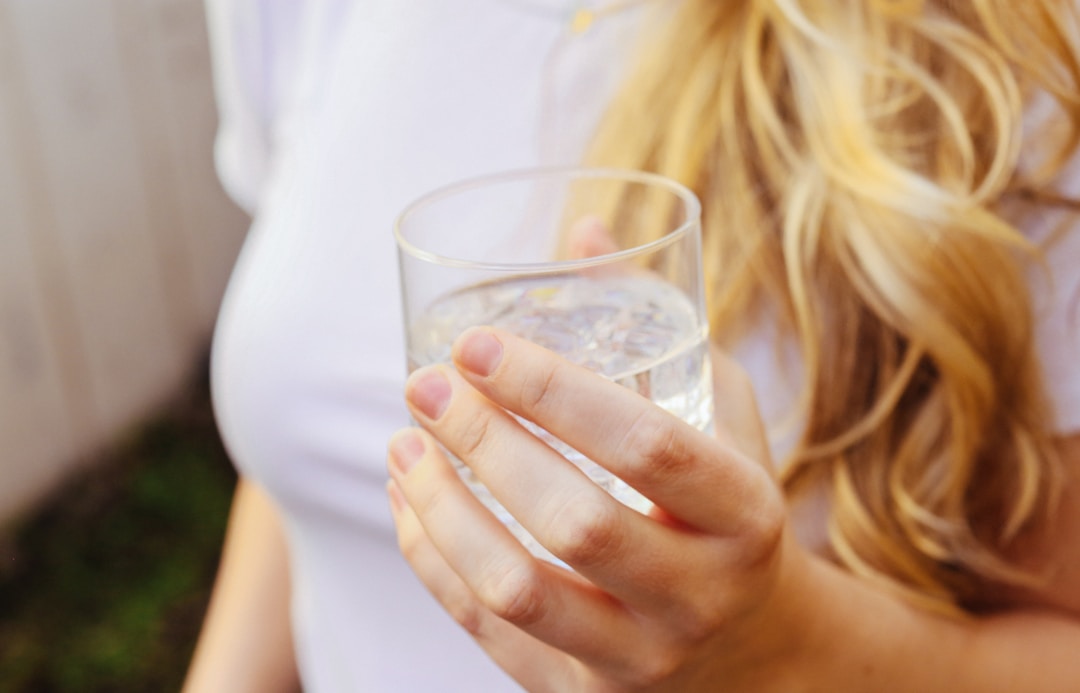 woman holding a glass of clean water