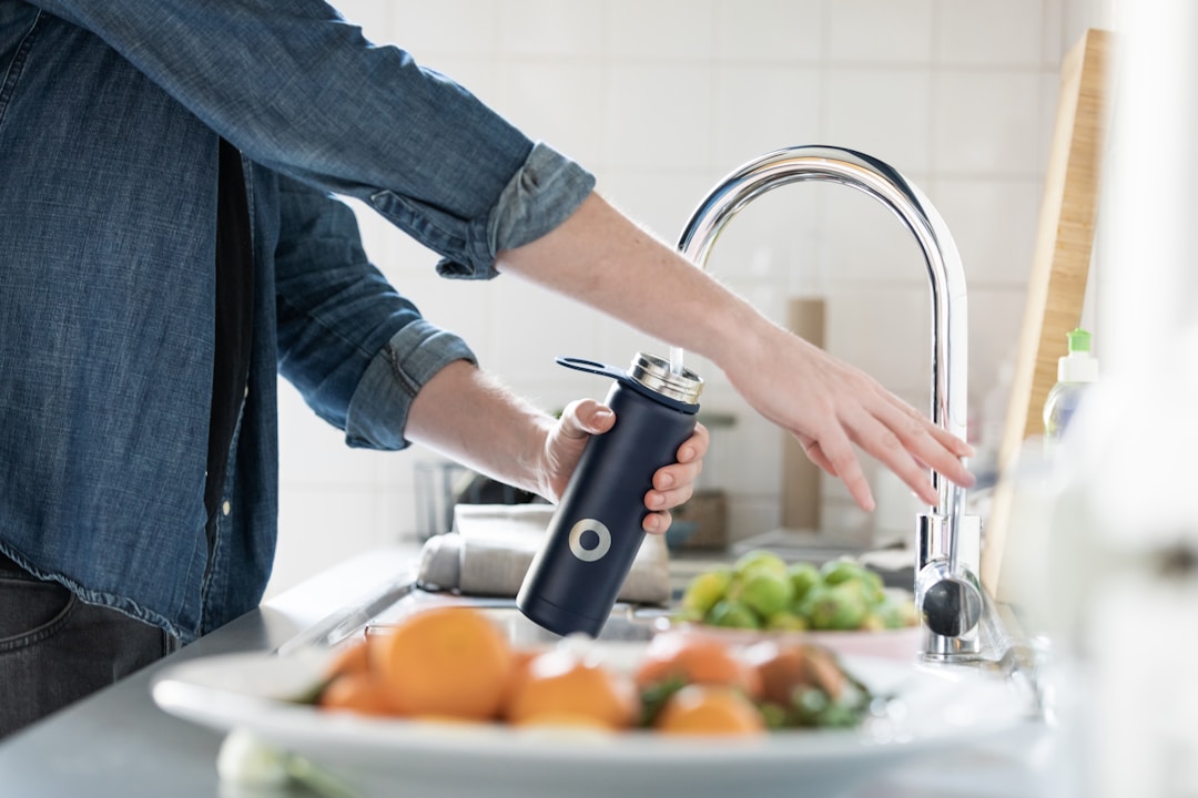 filling a water bottle in the sink