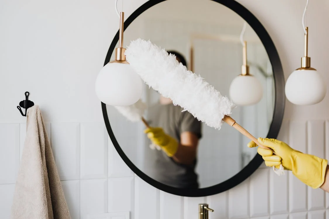 Bathroom Cleaning woman cleaning the mirror in the bathroom