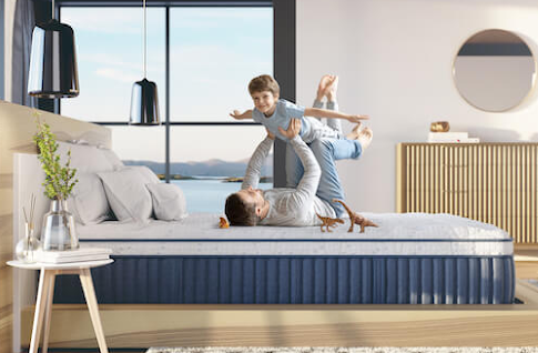 Father and son playing on a mattress