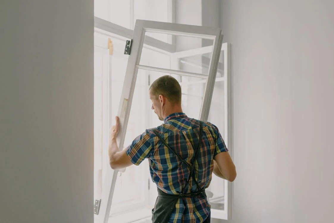 man installing door