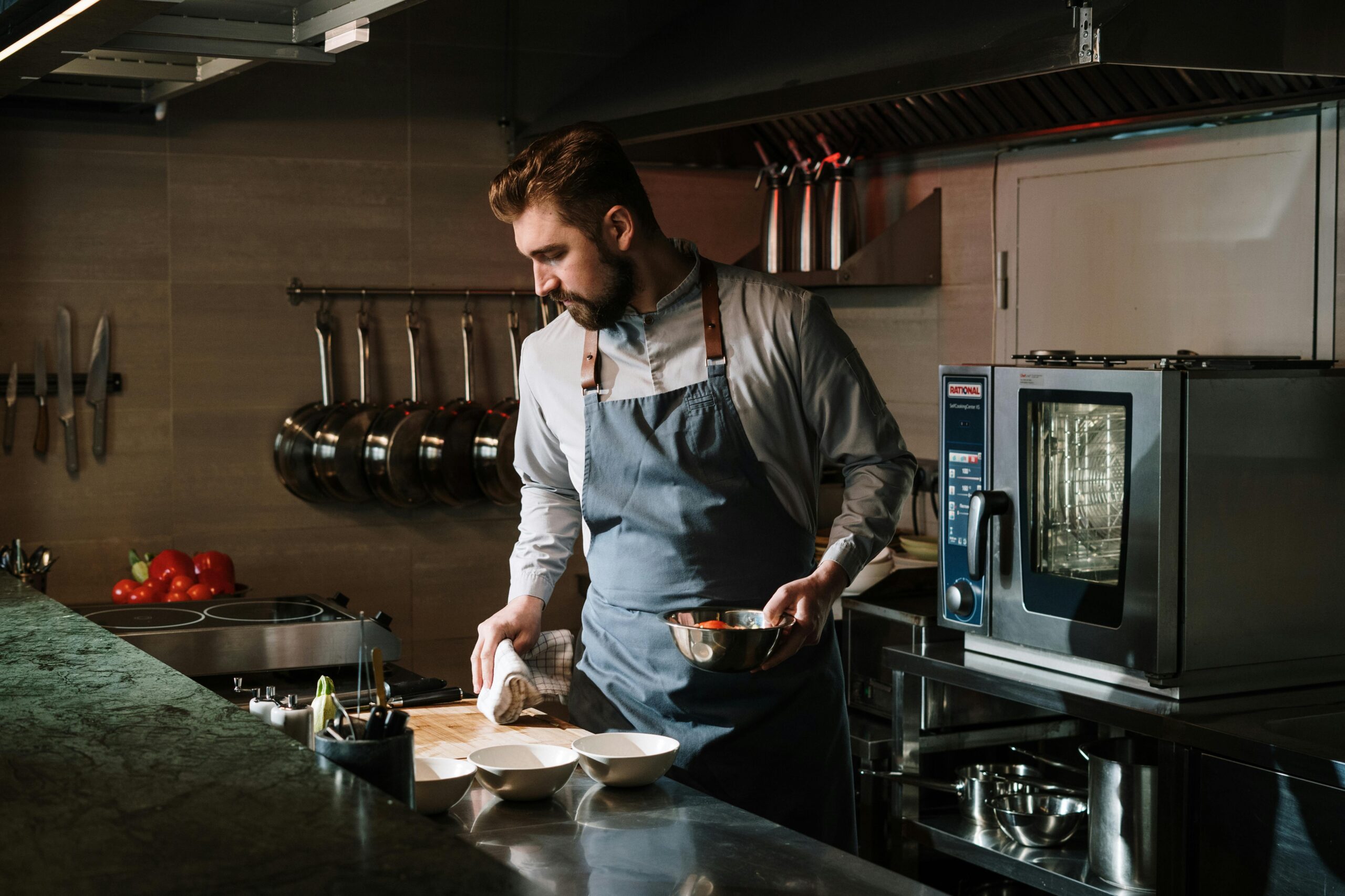 clean-modern-kitchen man standing in clean modern kitchen with high end cooking tools
