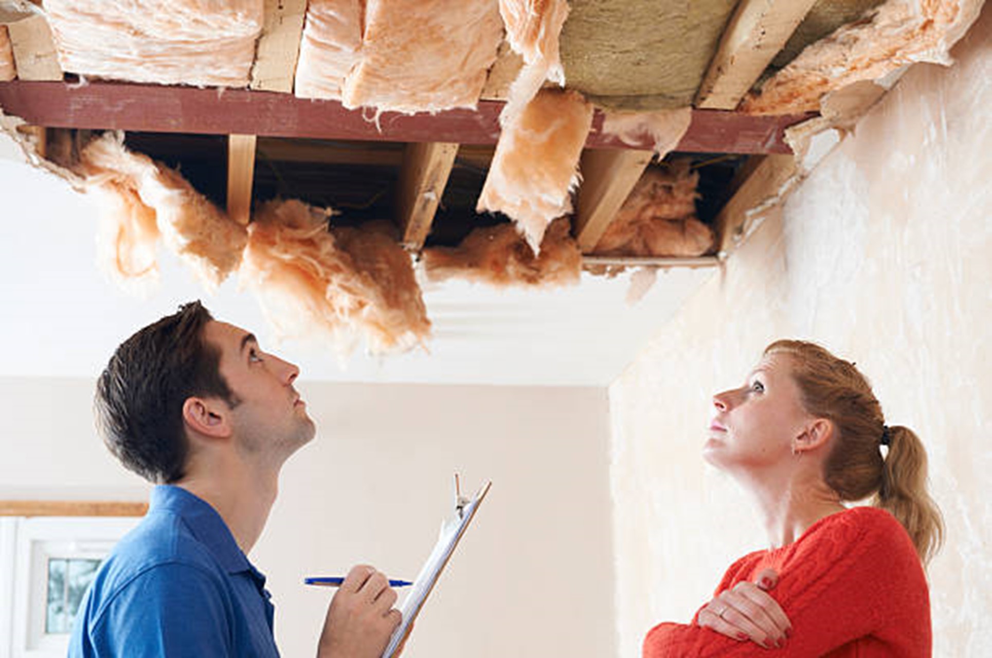 contractor inspecting ceiling contractor looking at drywall damage