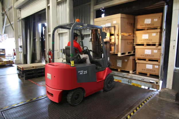 man unloading pallets with forklift