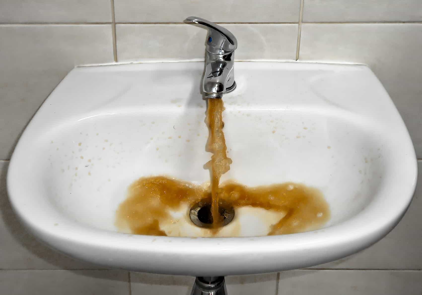 iron water flowing out of bathroom tap