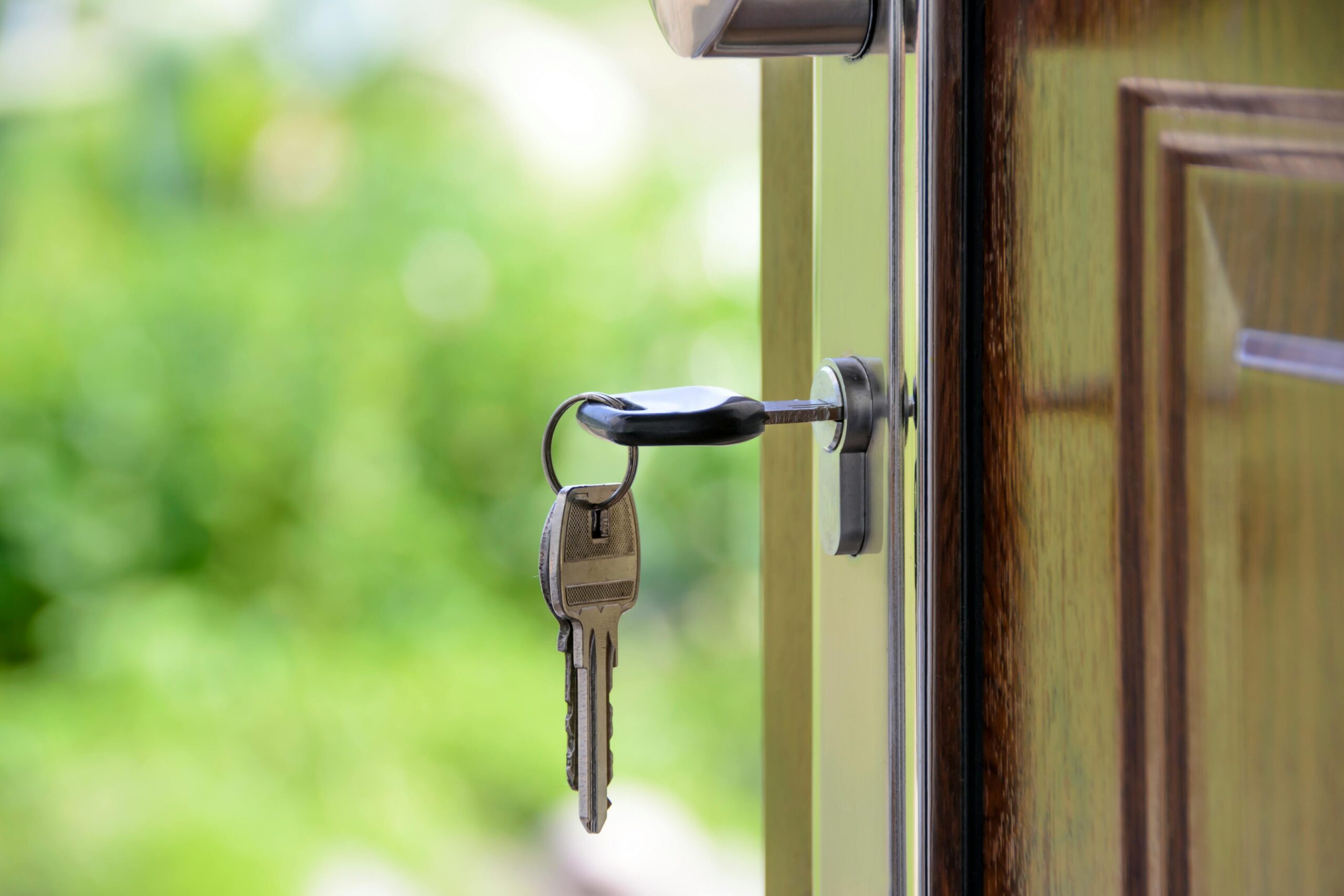 keys hanging from the door of a new home