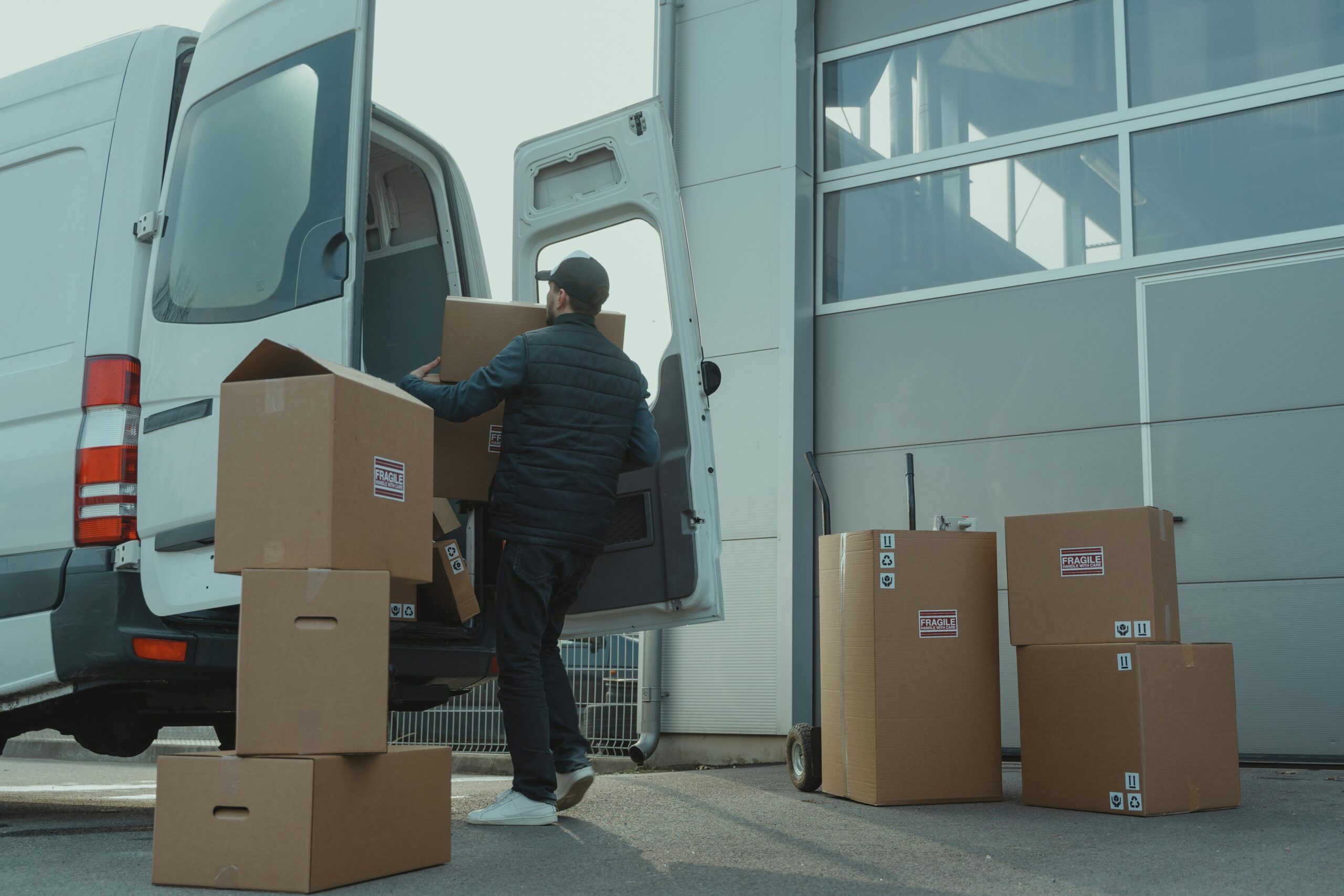 moving-van a man packing his fragile belongings into a moving van