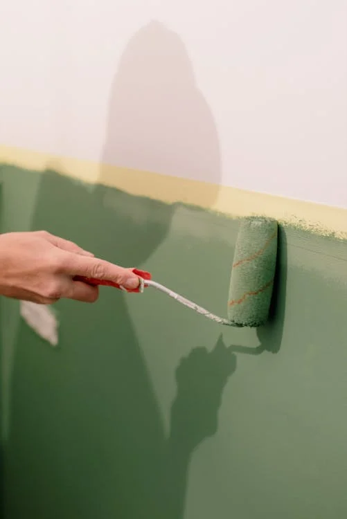 painting green paint with roller
