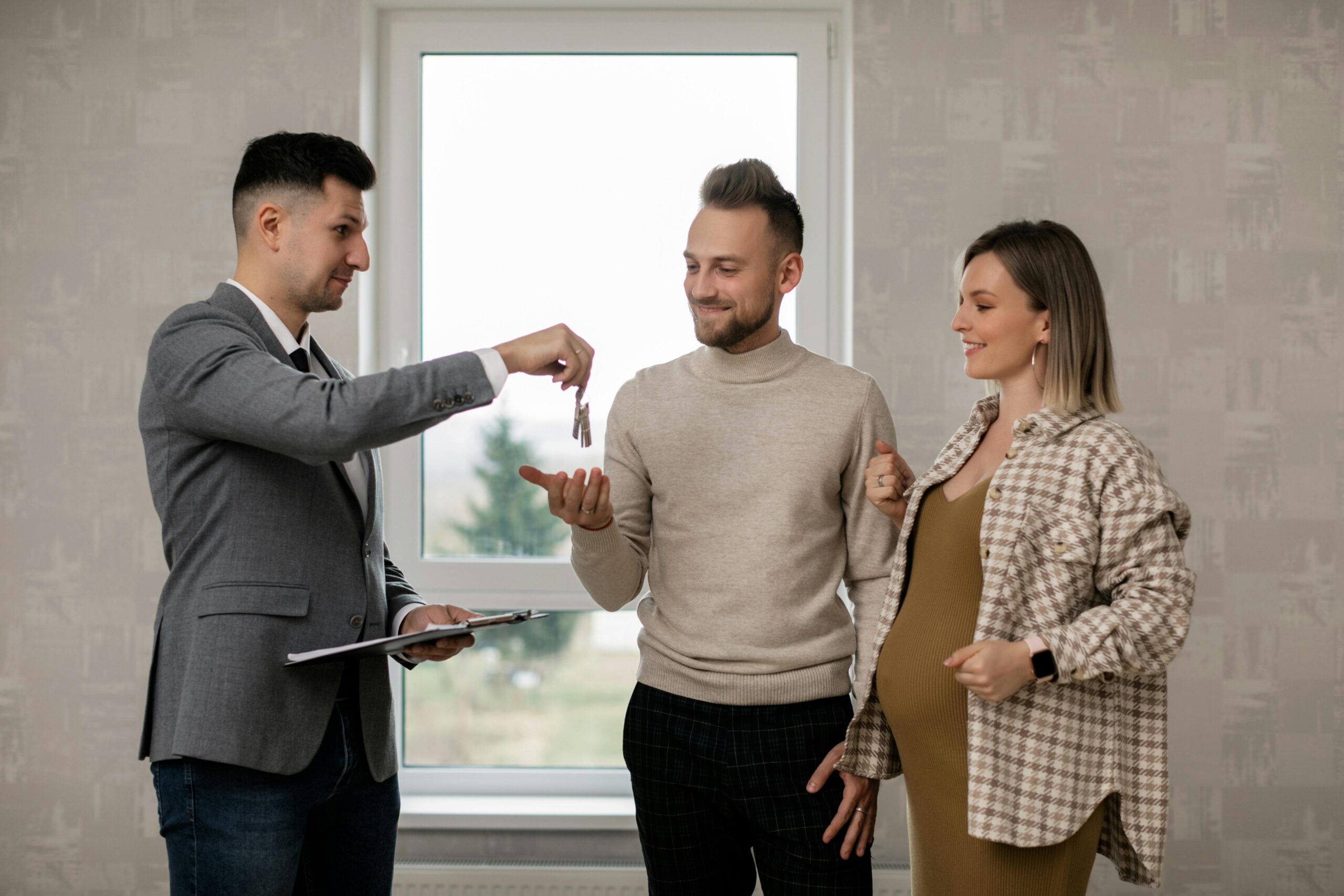 handing keys to young couple