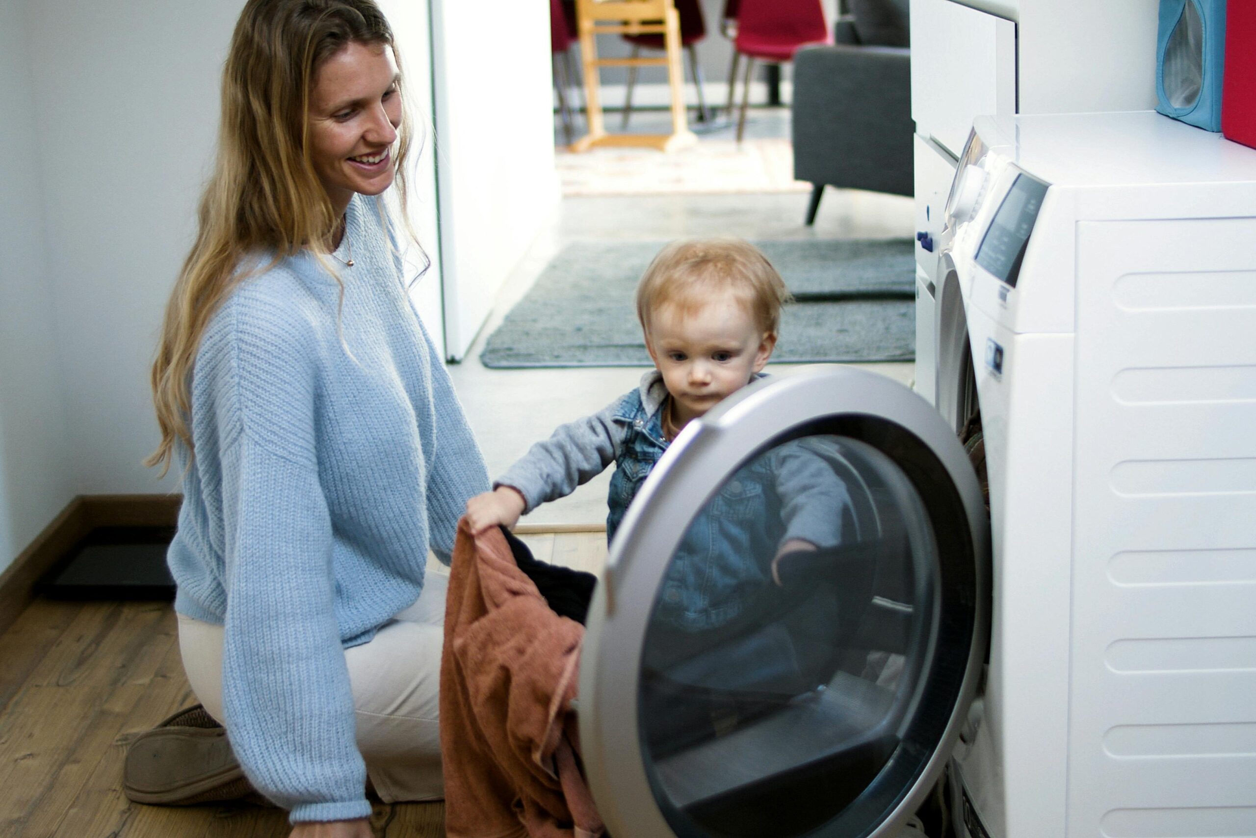 picture of a mother and her child loading the dryer