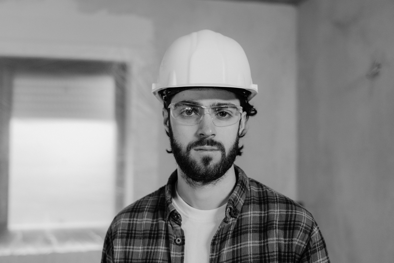 black and white image of contractor with hardhat
