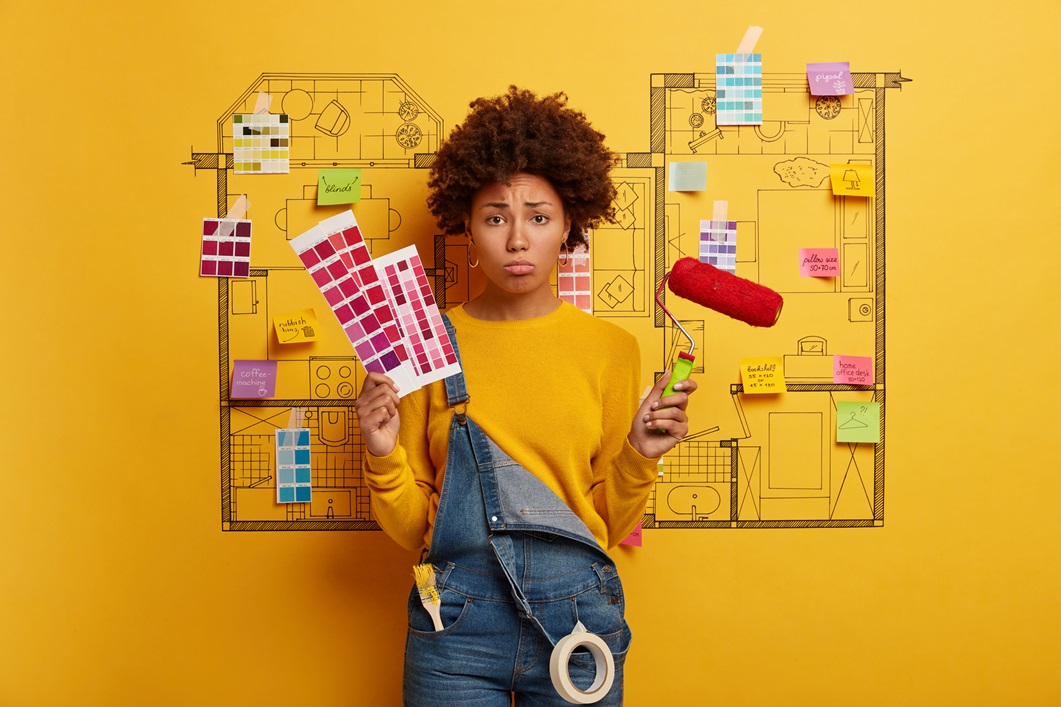 woman trying to decide on color scheme for paint woman deciding on paint and color selections