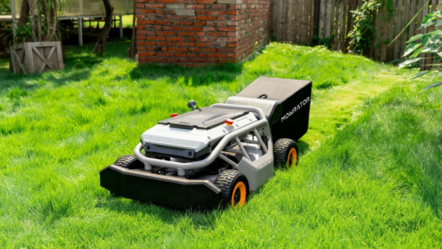 automatic lawn mower working remotely on cutting lawn