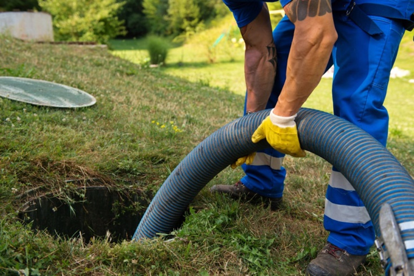 sewer cleaning plumber working on sewer drain