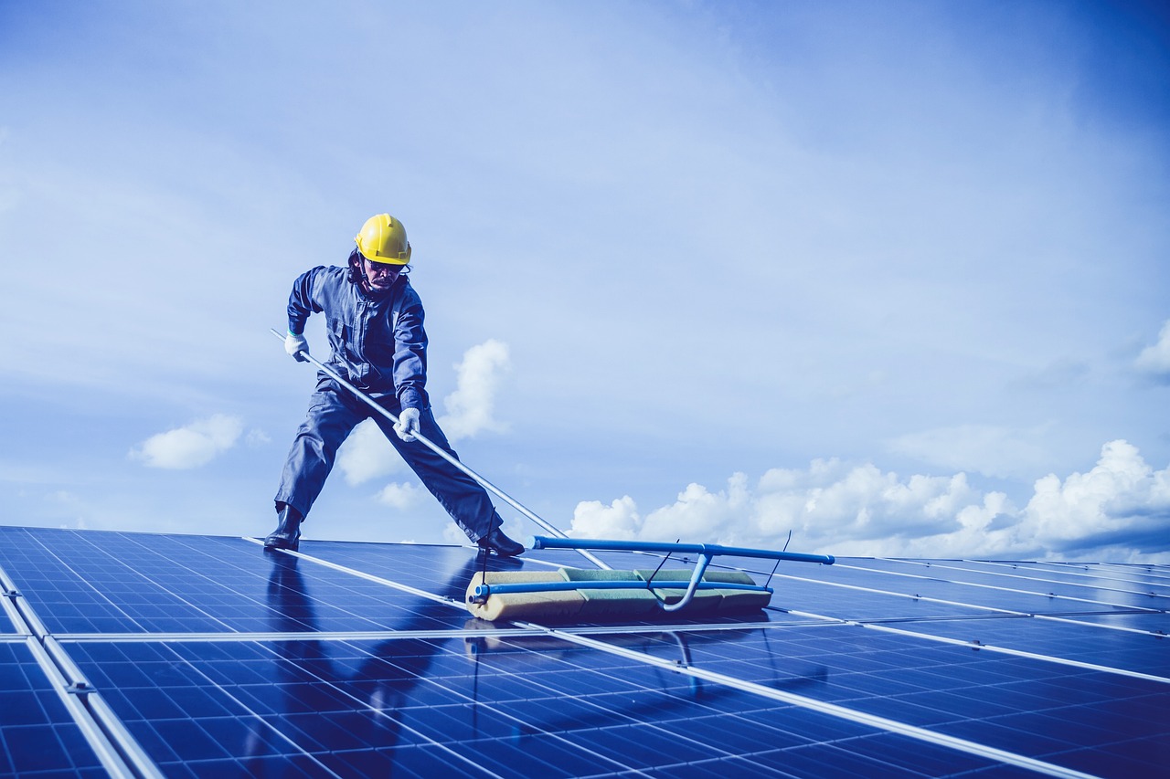 solar panel maintenance worker cleaning solar panels