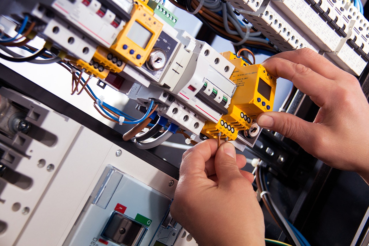 electronic-panel hands working on electronic panel