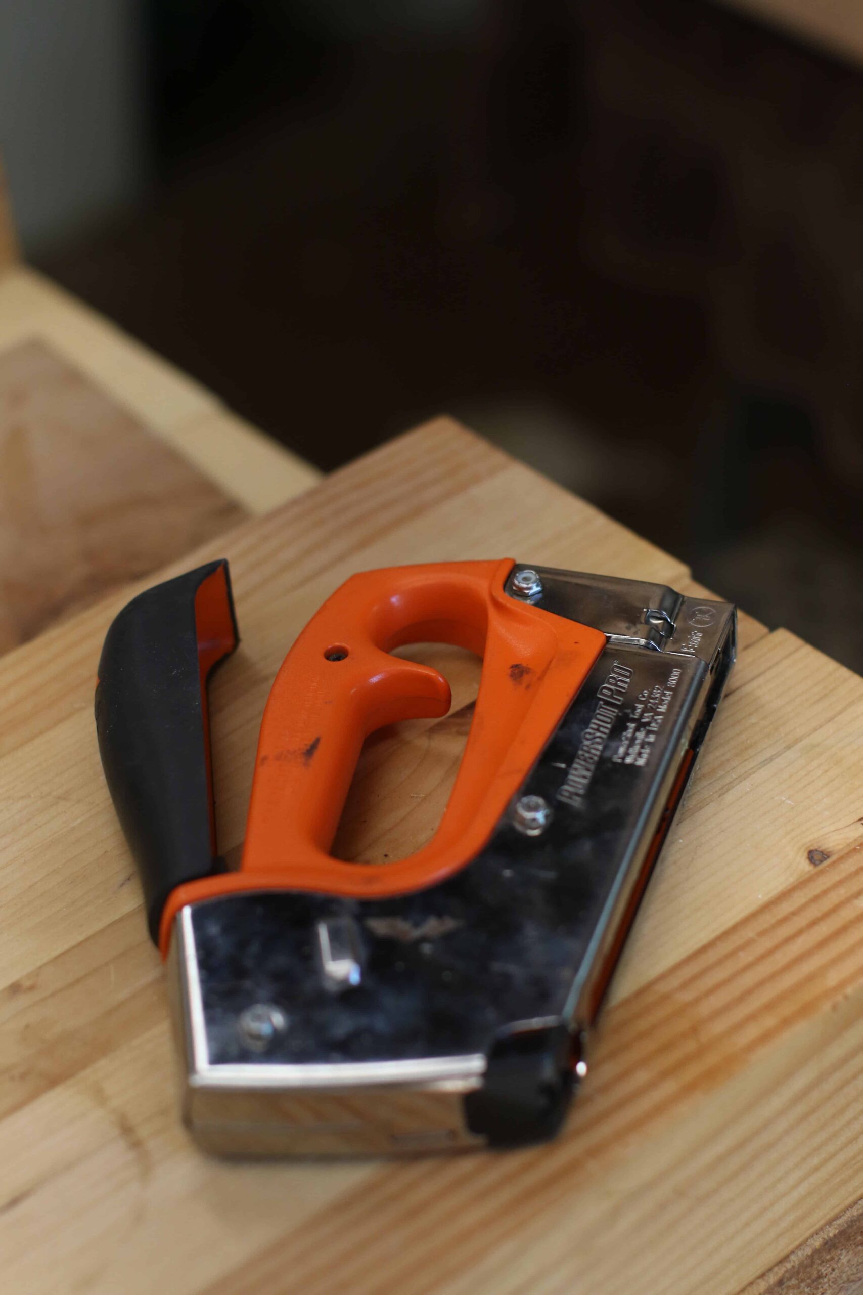 man using jackhammer on concrete wall