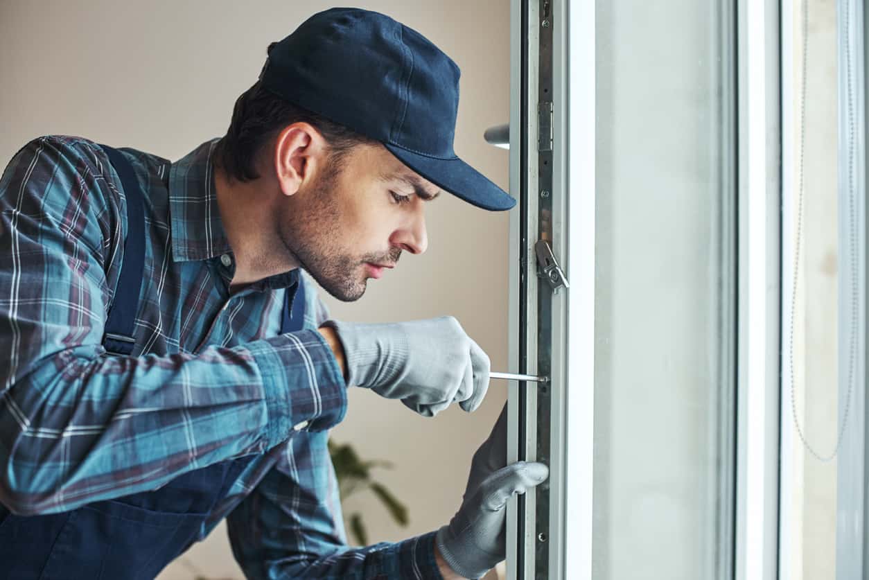 Master’s work. Close-up of young handyman setting new windows